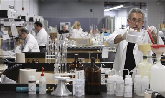 Laboratory technician Roger Avita pours a solution while working in the Manufacturing lab on Wednesday at Ultra Scientific Analytical, a company that develops water purification standards and testing, in North Kingstown, R.I. The company is looking to add 15 to 20 employees to the 49 currently employed over the next year but is having difficulty finding qualified workers.